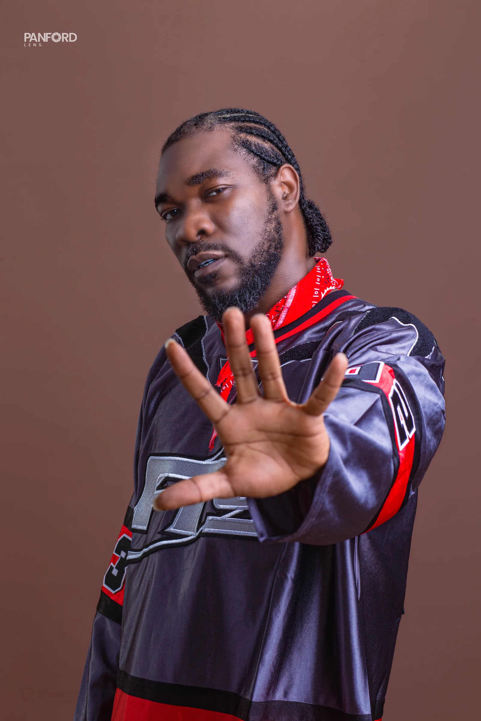 Close portrait of Kobby Major reaching toward the camera